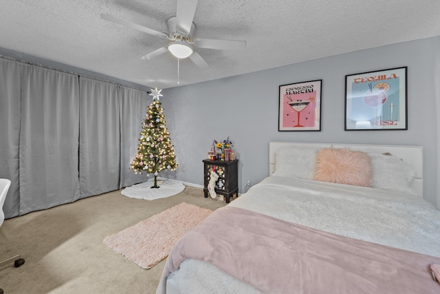 carpeted bedroom featuring ceiling fan and a textured ceiling