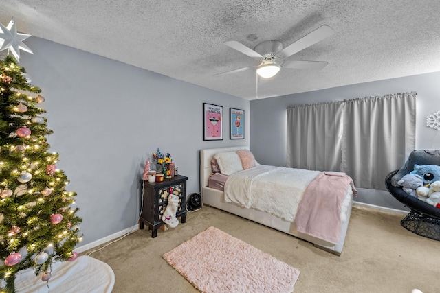 bedroom featuring ceiling fan, light carpet, and a textured ceiling