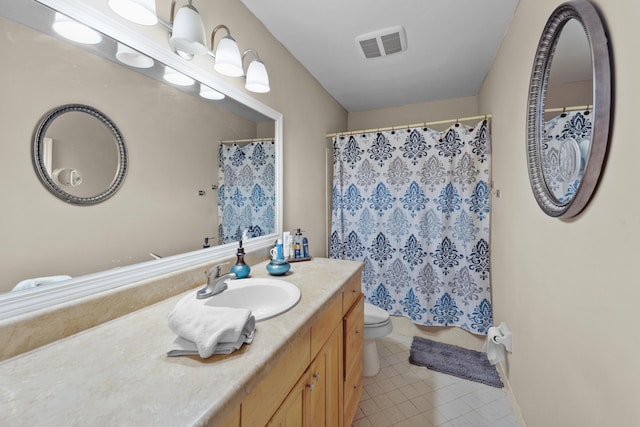 bathroom with a shower with curtain, vanity, tile patterned floors, and toilet