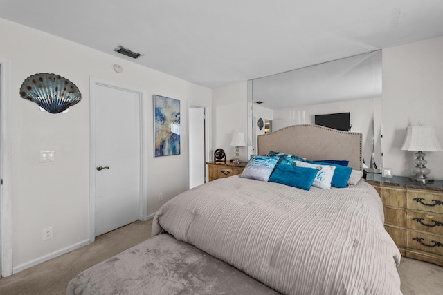 bedroom featuring light colored carpet