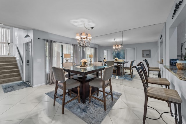 tiled dining area with an inviting chandelier