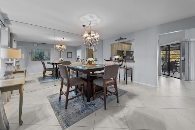 dining area featuring an inviting chandelier and light tile patterned floors