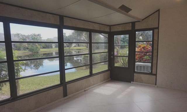 unfurnished sunroom with a water view