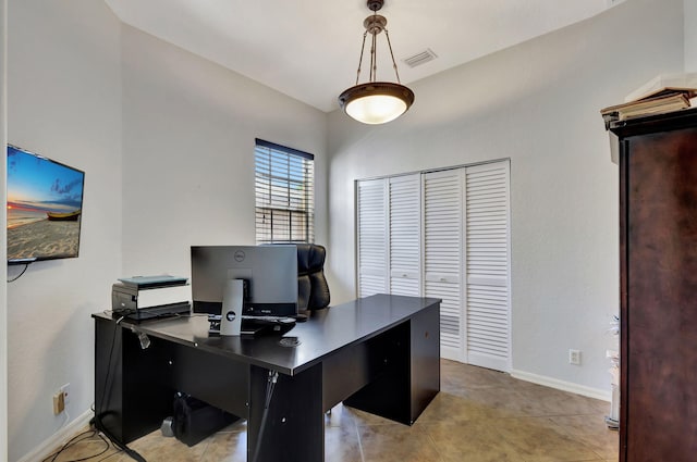 office space featuring baseboards, visible vents, and light tile patterned flooring