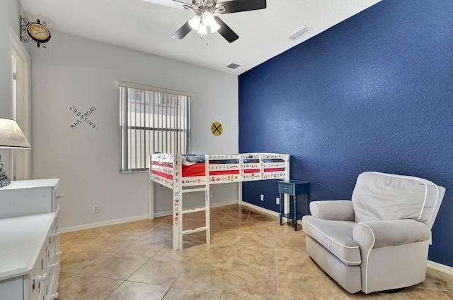 bedroom featuring light tile patterned floors, a ceiling fan, visible vents, and baseboards