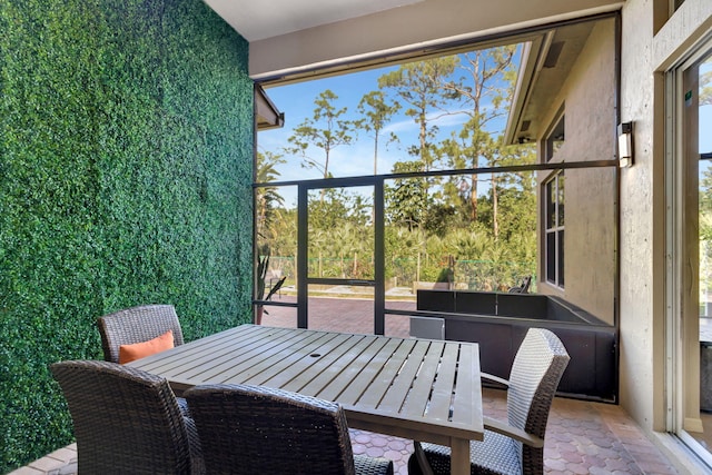 sunroom / solarium featuring outdoor dining space and plenty of natural light