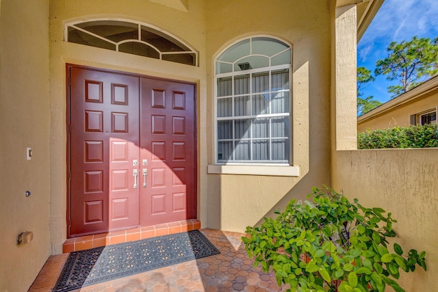 property entrance with stucco siding