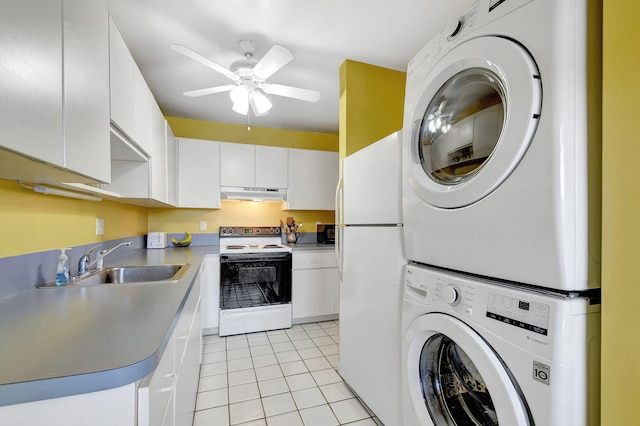 kitchen with light tile patterned floors, white appliances, sink, stacked washer / drying machine, and white cabinets