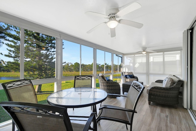 sunroom / solarium featuring ceiling fan