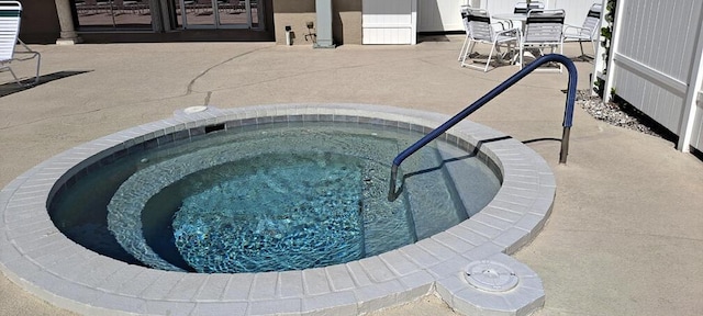 view of swimming pool featuring a patio area and an in ground hot tub