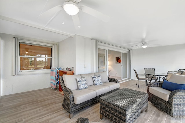 living room featuring light hardwood / wood-style floors and ceiling fan