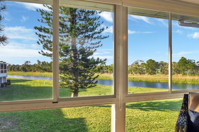 unfurnished sunroom featuring a water view