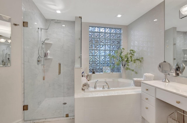 bathroom with shower with separate bathtub and vanity