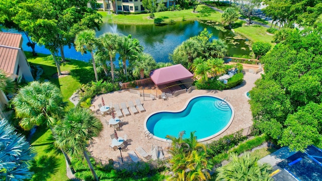 view of pool featuring a water view and a patio area