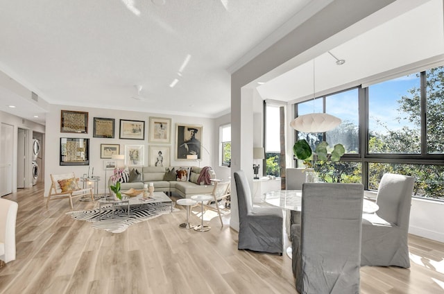 dining space featuring crown molding and light hardwood / wood-style floors