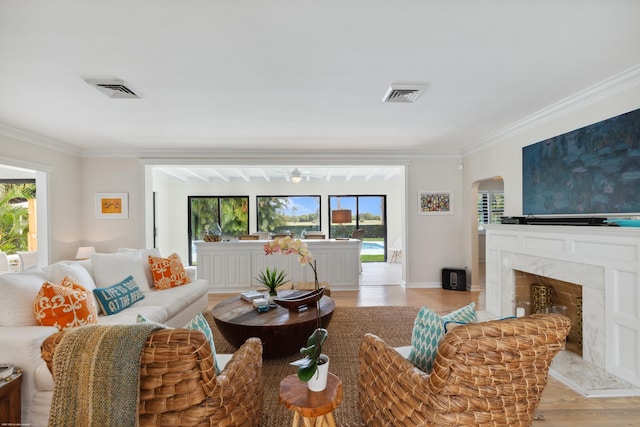 living room featuring ornamental molding and a healthy amount of sunlight