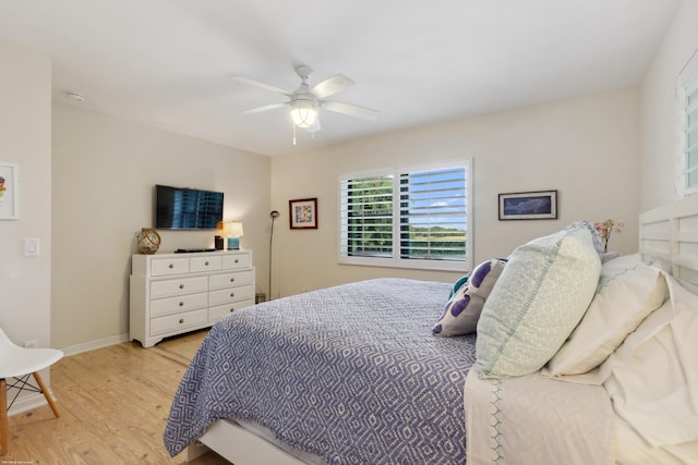 bedroom with light hardwood / wood-style flooring and ceiling fan