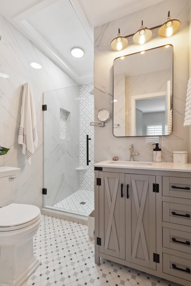 bathroom with walk in shower, vanity, and toilet