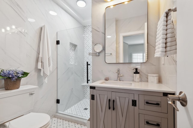 bathroom with tile walls, backsplash, vanity, a shower with shower door, and toilet