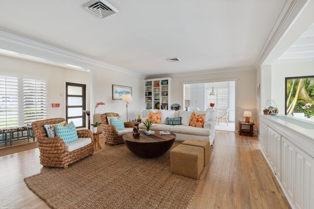 living room with ornamental molding and light wood-type flooring