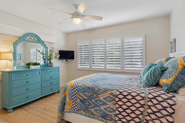 bedroom with ceiling fan and light hardwood / wood-style floors