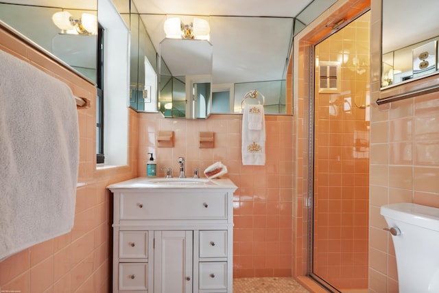 bathroom featuring vanity, a shower with shower door, and tile walls