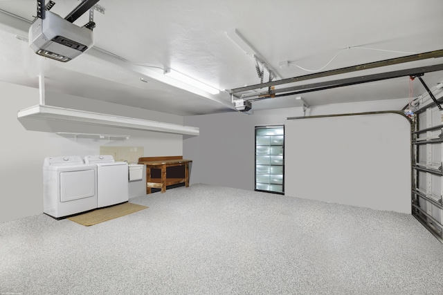 garage featuring a garage door opener and separate washer and dryer