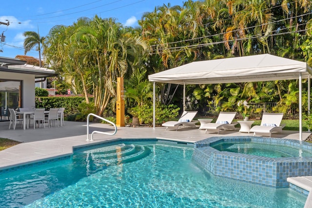 view of swimming pool with an in ground hot tub and a patio area