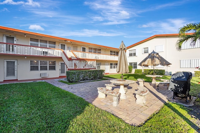 surrounding community with a patio area and a lawn