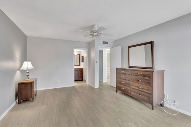 bedroom featuring ensuite bathroom, ceiling fan, visible vents, baseboards, and light wood finished floors