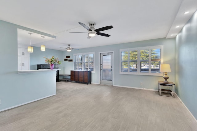 living room with ceiling fan, light wood finished floors, recessed lighting, and baseboards