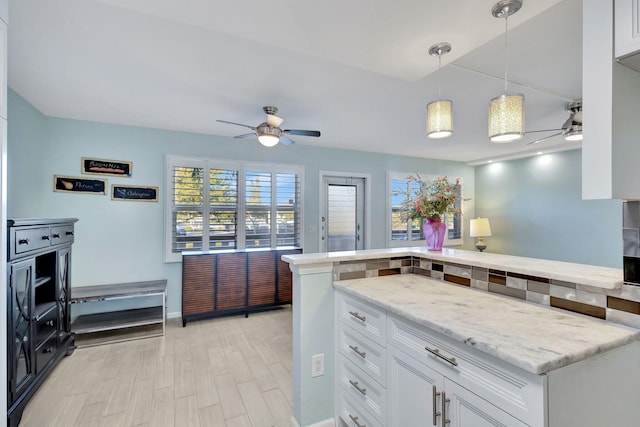 kitchen featuring a healthy amount of sunlight, white cabinetry, pendant lighting, and a ceiling fan