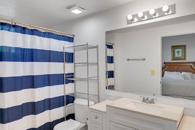 ensuite bathroom with toilet, curtained shower, vanity, and connected bathroom