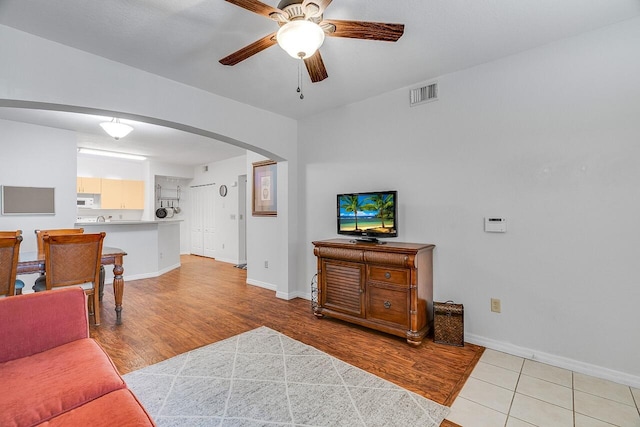 living room with ceiling fan and light hardwood / wood-style floors