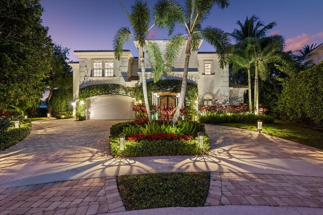 mediterranean / spanish house with a garage