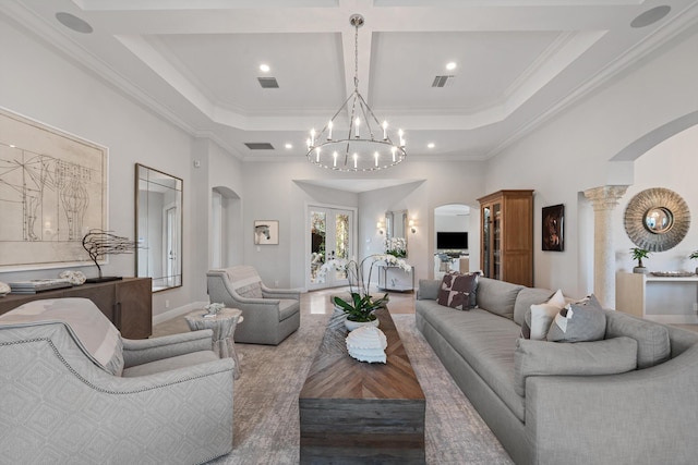 living room with an inviting chandelier, ornamental molding, coffered ceiling, and a high ceiling