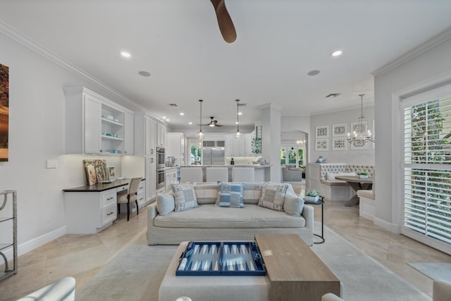 living room with ornamental molding, a healthy amount of sunlight, and ceiling fan with notable chandelier