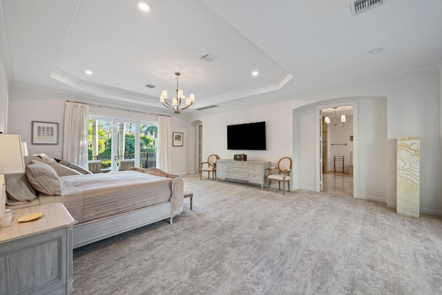 carpeted bedroom featuring ornamental molding, an inviting chandelier, and a tray ceiling