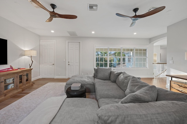 living room with ceiling fan and light wood-type flooring