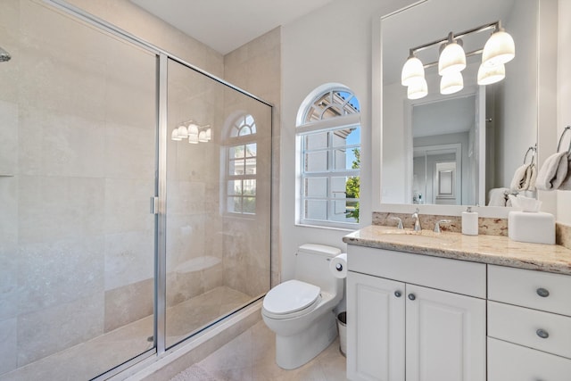 bathroom with vanity, toilet, tile patterned floors, and a shower with shower door