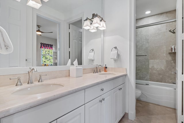 full bathroom featuring ceiling fan, tile patterned flooring, vanity, toilet, and tiled shower / bath