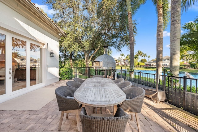 view of patio / terrace featuring a water view and french doors