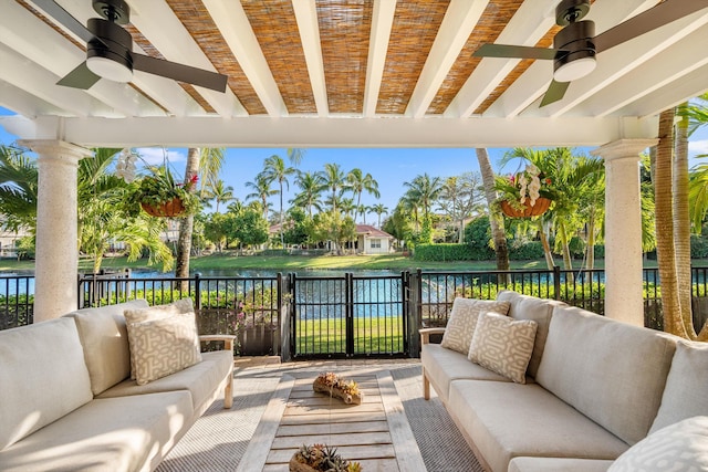 view of patio / terrace with a water view, ceiling fan, and outdoor lounge area