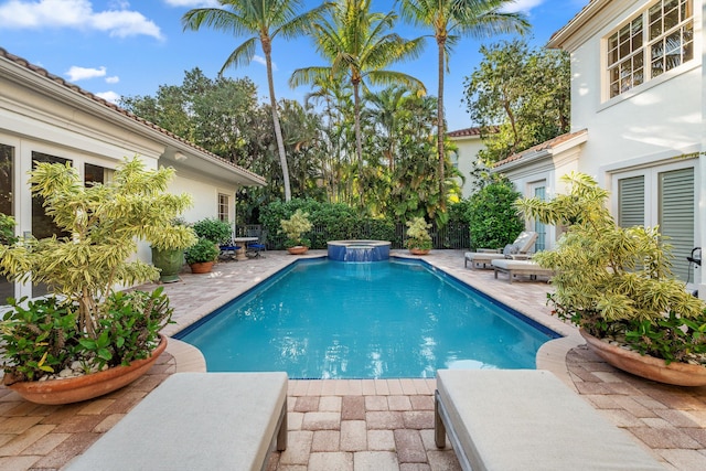 view of pool with a patio and an in ground hot tub