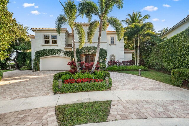 mediterranean / spanish-style house with a garage