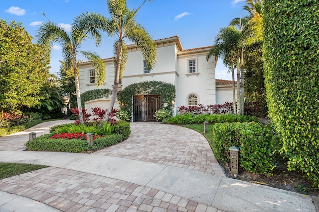 mediterranean / spanish home with a garage