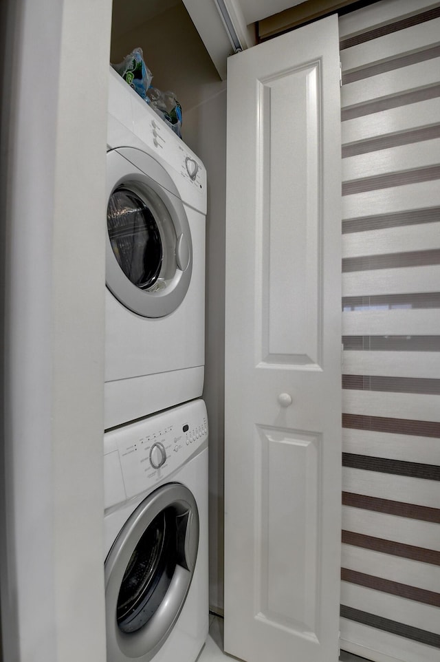 laundry room featuring stacked washing maching and dryer