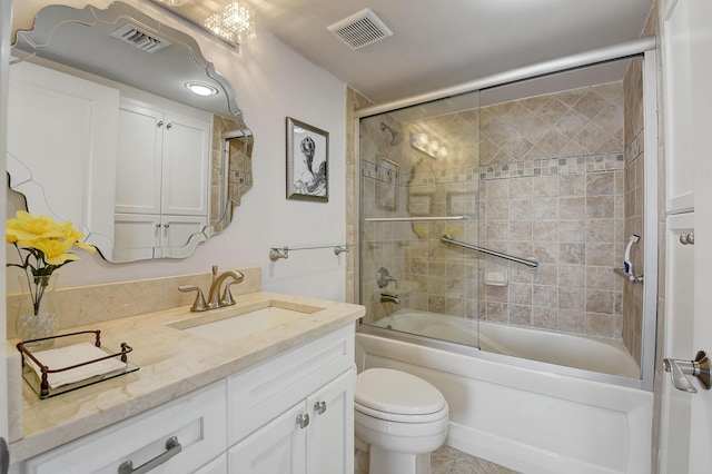 full bathroom with vanity, toilet, and bath / shower combo with glass door