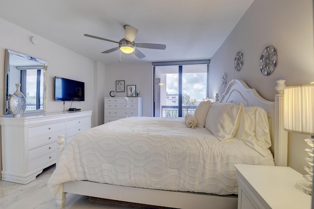 bedroom featuring access to outside, ceiling fan, and a wall of windows