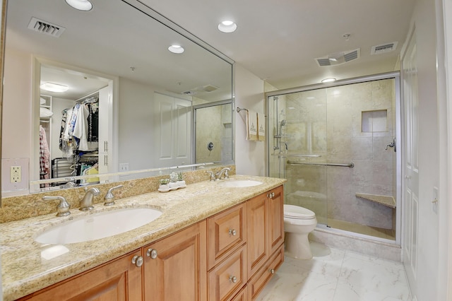 bathroom with an enclosed shower, vanity, and toilet